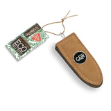 A durable and eco-friendly dog toy made from natural jute and soft suede in the shape of a bullet, perfect for sustainable pet play.