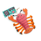 Eco-friendly lobster-shaped dog toy made from natural suede, jute fibre stuffing, and plaited jute rope legs. Perfect for chewing and tugging.