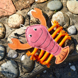 Eco-friendly lobster-shaped dog toy made from natural suede, jute fibre stuffing, and plaited jute rope legs. Perfect for chewing and tugging.