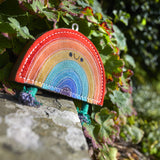Eco-friendly Rainbow Warrior dog toy made from natural jute and soft suede, featuring rope legs for tugging and fetching fun.