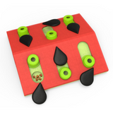Pink Nina Ottosson Melon Madness cat puzzle with pegs and seed compartments for treat-hunting fun.