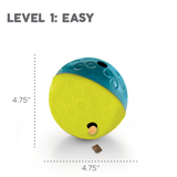 Bright blue and yellow Nina Ottosson Treat Tumble dog puzzle toy dispensing treats as a dog plays.