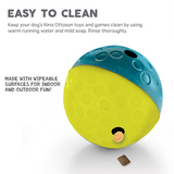 Bright blue and yellow Nina Ottosson Treat Tumble dog puzzle toy dispensing treats as a dog plays.