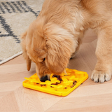 Dog eating off foraging mat