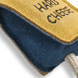 Eco-friendly cheese-shaped dog toy with a suede outer, natural jute stuffing, and jute rope legs, ideal for safe, sustainable play.
